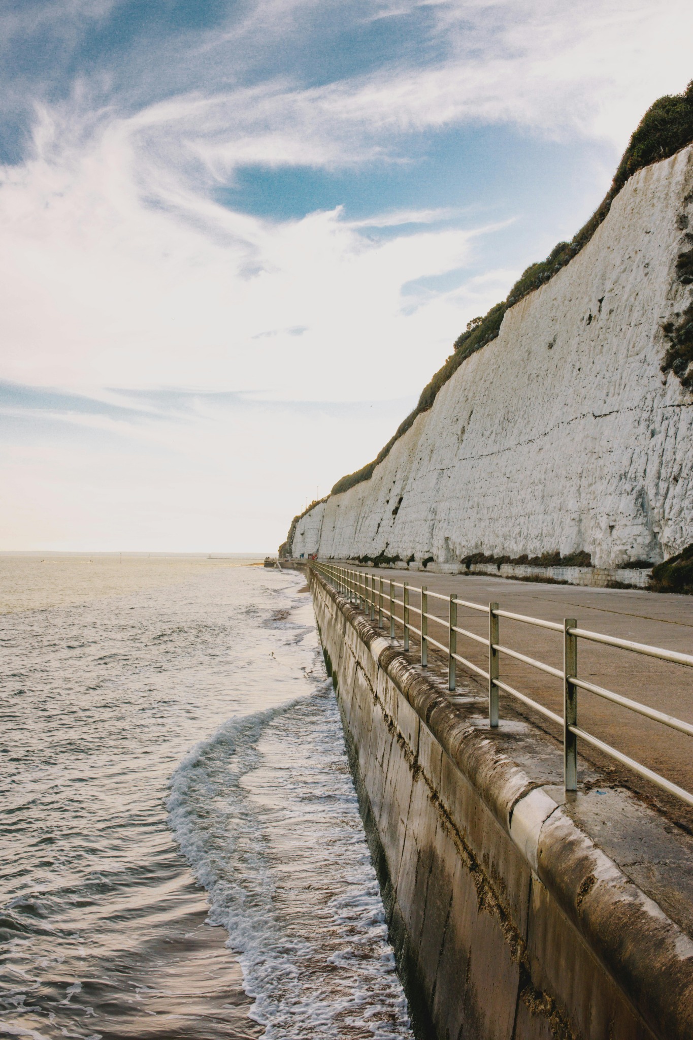 Seafront walkway beneath white cliffs